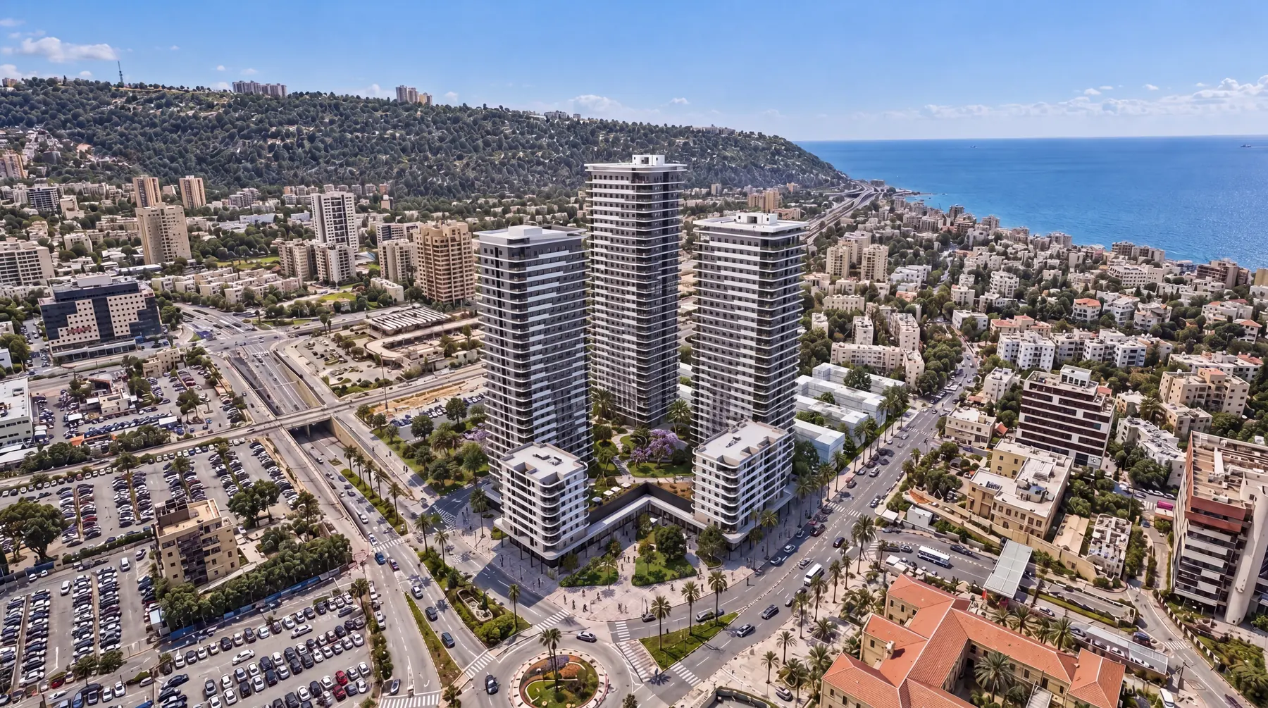 הדמיית הפרויקט — מבט אווירי על שלושת המגדלים, הכרמל והים